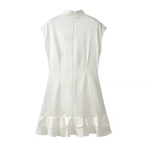 Back view of a white sleeveless mini dress featuring a ruffled hem and damask fabric