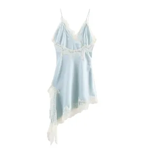 Close-up of light blue satin dress with white lace trim and asymmetrical hem