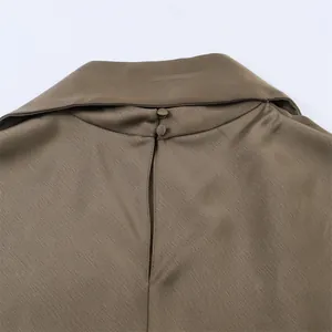 Close-up of silk satin dress back with two-button closure and slit