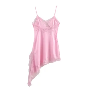 Detailed view of pink satin dress featuring delicate lace trim and asymmetrical hem