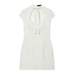 Close-up of elegant white sleeveless dress featuring bow-knot and keyhole cutout