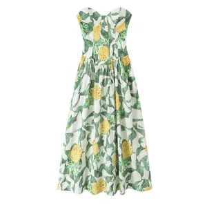 Detailed front view of a vibrant tropical pineapple print bustier style maxi dress