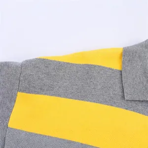 Detailed macro view of yellow and grey striped knit sweater with soft fabric texture