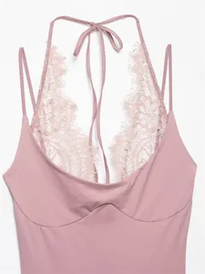 Close-up detail of a pink halter neck bodysuit with elegant floral lace splicing and ties