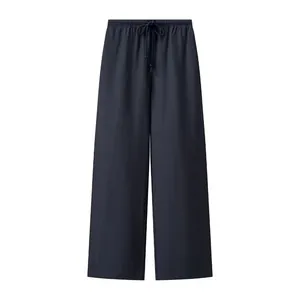 Detail view of dark navy wide-leg trousers featuring elastic waist and drawstring design