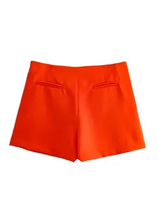 Detailed rear view of vibrant orange high-waisted skort with classic back welt pockets
