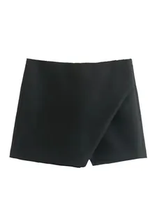 Detail view of black high-waisted asymmetric skort with elegant wrap-front design