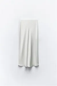 Detail view of the elegant satin texture and fluid drape of this white midi skirt