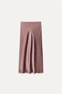 Detailed view of the smooth satin texture and elegant drape of a dusty rose midi skirt