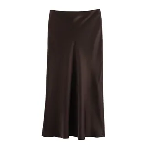Detailed macro view of a dark brown satin midi skirt showing elegant silky sheen
