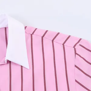 Close-up detail of a pink striped shirt featuring a white contrast collar and shoulder