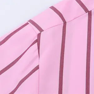 Detailed macro shot of fine stitching on high-quality pink fabric with burgundy stripes