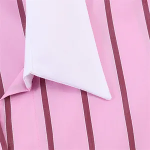 Close-up detail of white pointed collar on pink and burgundy striped shirt fabric