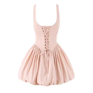 Detailed front view of a light pink puff skirt mini dress with corset-style waist