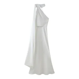 Elegant white halter neck maxi dress with cutout waist and flowing sash detail.