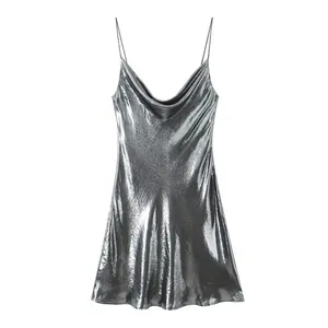 Close-up of metallic silver slip dress showing cowl neck detail and fabric texture