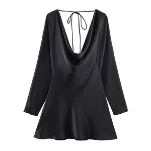 Rear view of black satin cowl neck mini dress with open back and tie detail