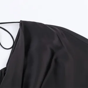 Close-up view showing the high-quality black satin fabric and texture of the dress detail