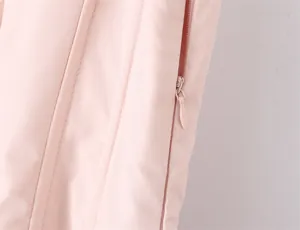 Detailed view of hidden zipper and boning structure on elegant pink corset dress