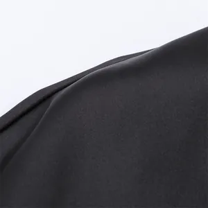 Macro detail shot showing the smooth and shiny texture of black silk satin fabric
