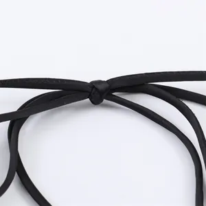 Close-up of black satin strap knot detail for sexy evening dress