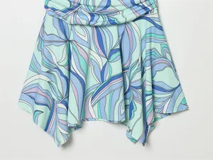 Detailed view of the flared skirt with a blue abstract wave pattern on summer halter dress
