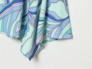 Detailed view of the flared hem on a vibrant abstract floral print summer halter dress
