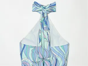 Detailed view of the elegant halter neck tie on a blue abstract floral print summer dress