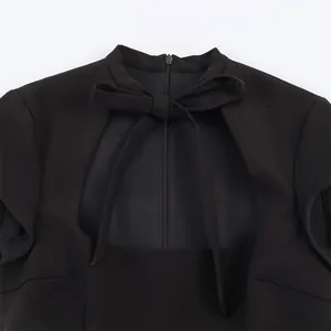 Detailed view of black sexy dress featuring a stylish hollow-out neckline and bow tie