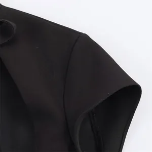 Macro view of shoulder sleeve and bow-knot detail on black elegant sexy mini dress