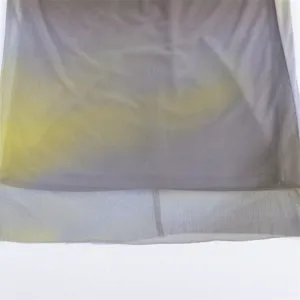 Macro detail of the gradient yellow and grey printed mesh fabric texture and hemline