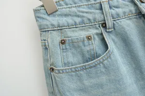 Close-up of front pocket and metal rivets on vintage light blue low waist denim jeans