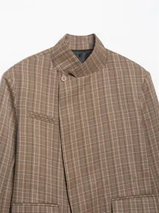 Detail view of women's elegant brown plaid blazer featuring a high stand collar.