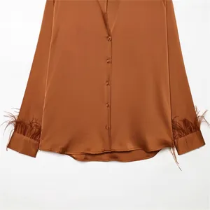 Loose copper satin shirt for women featuring elegant feather-trimmed cuffs.