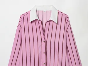 Detailed view of a pink striped shirt featuring a contrasting white lapel collar and buttons