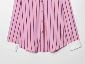 Close-up detail of a pink striped long-sleeve shirt featuring white contrast cuffs