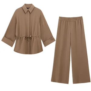 Elegant brown two-piece set featuring a long-sleeved drawstring shirt and wide-leg pants