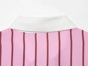 Detailed macro shot of the crisp white collar on a pink and red vertical striped shirt.