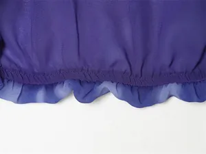 Close-up view of the elasticated ruffled hem on a purple chiffon top or skirt
