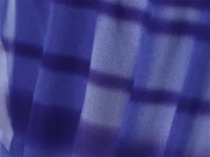Close-up detail of lightweight blue and purple gradient plaid chiffon fabric texture
