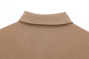 Close-up view of a brown textured casual shirt collar with professional stitching details