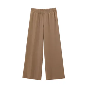 Close-up detail of women's casual brown wide-leg trousers featuring a comfy elastic waistband