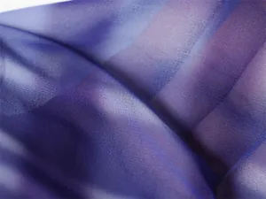 Detailed close-up showing the soft texture and purple gradient of sheer chiffon fabric
