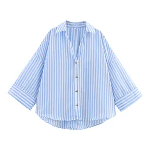 Detailed close-up of blue and white vertical striped shirt featuring a wide sleeve design