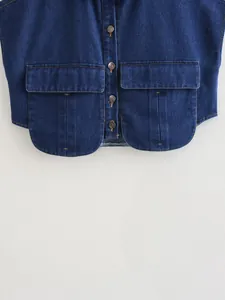 Detail shot of a dark blue denim crop vest featuring flap pockets and vintage buttons.