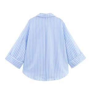 Back view of light blue and white vertical striped wide sleeve oversized shirt