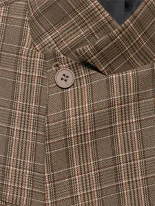 Macro detail shot showing the texture of brown checkered plaid fabric and a matching button