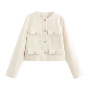 Close-up of cream tweed short jacket with elegant gold buttons and four flap pockets
