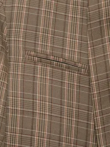 Detailed view of the brown check pattern fabric and pocket on a stylish women's blazer jacket.