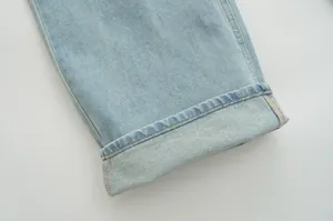 Detailed close-up view of a light blue denim jeans hem with quality stitching and fabric